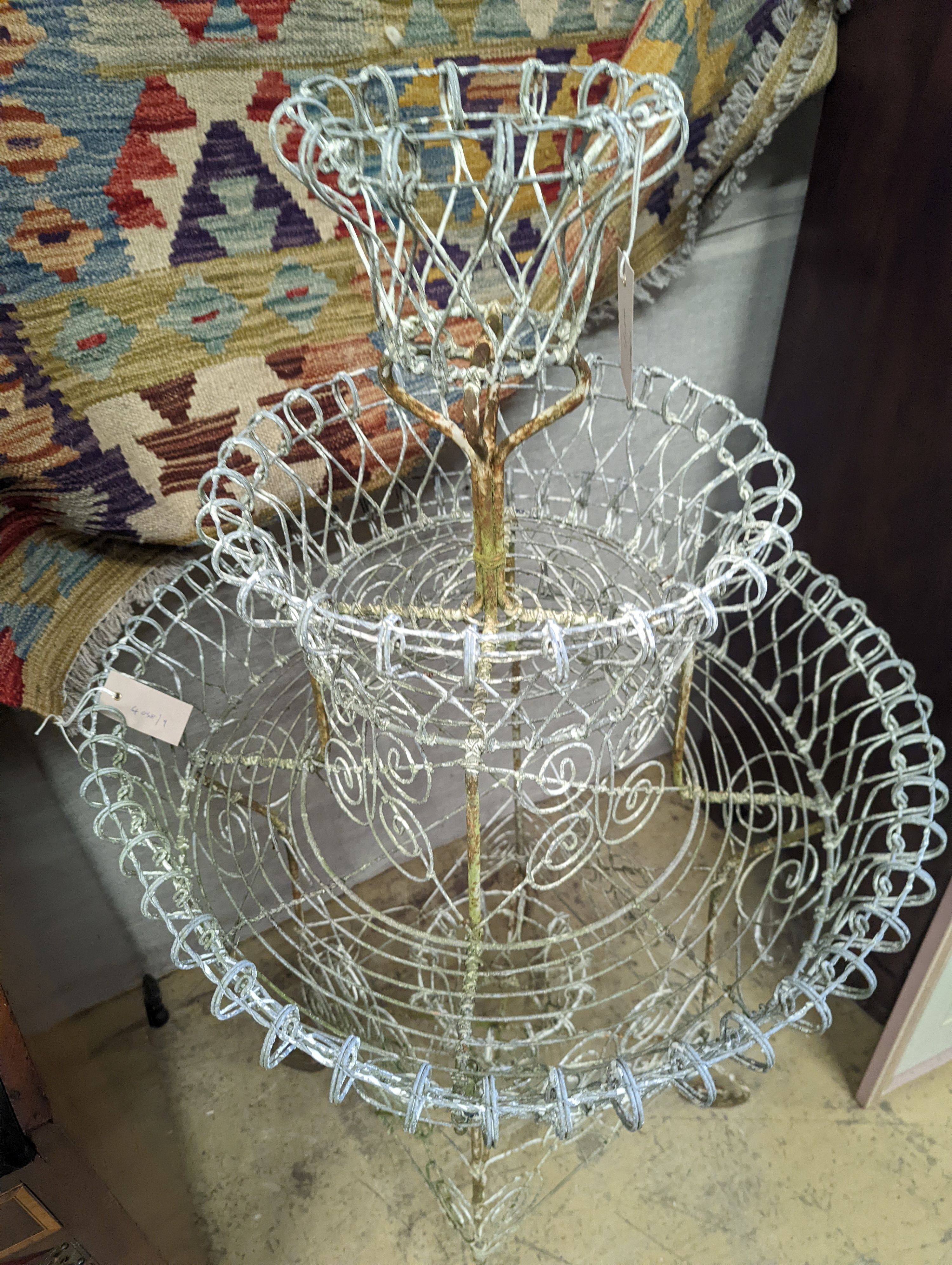 A Victorian painted wirework three tiered plant stand, diameter 65cm, height 112cm